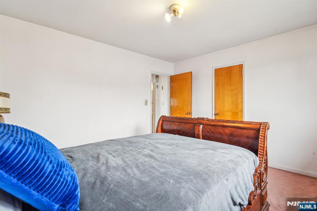 163 Kent Street Hackensack, NJ 07601 - Photo 13 of 19 a bedroom with a bed and window