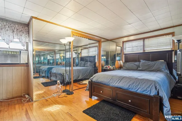 a bedroom with a bed and glass door