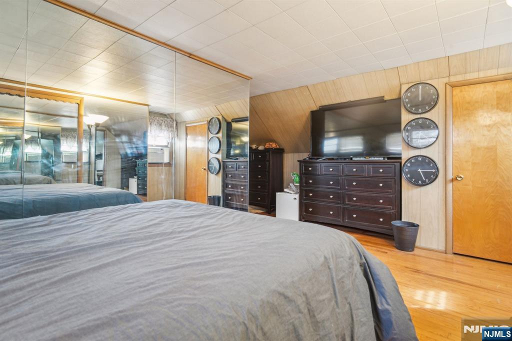 163 Kent Street Hackensack, NJ 07601 - Photo 18 of 19 a large bedroom with a bed and a mirror