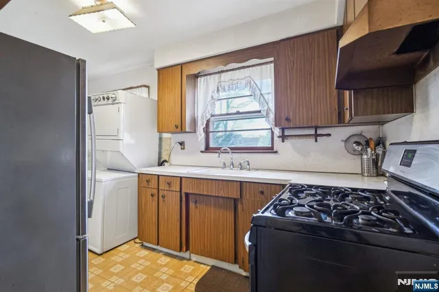 a kitchen with a stove a sink and a refrigerator