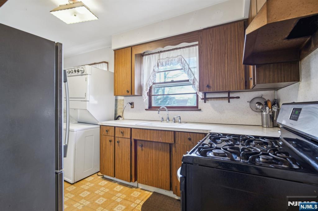 163 Kent Street Hackensack, NJ 07601 - Photo 10 of 19 a kitchen with a stove a sink and a refrigerator