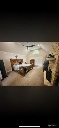 a bedroom with furniture and a window