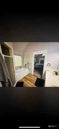 a balcony with furniture and wooden floor