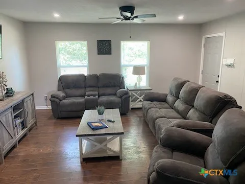 a living room with furniture window and wooden floor