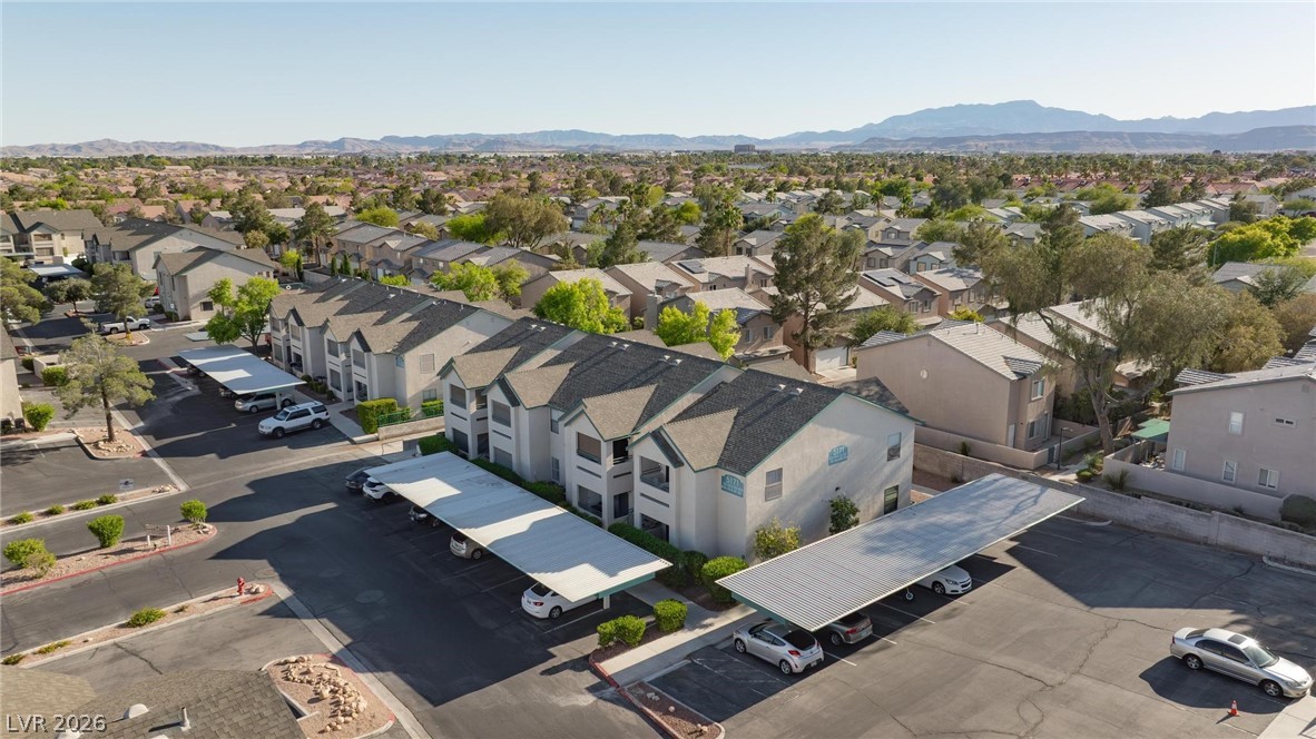 5171 South Lindell Road, Unit 103 Las Vegas, NV 89118 - Photo 22 of 24 An aerial perspective reveals a vibrant community with multi-level residences and ample covered parking.