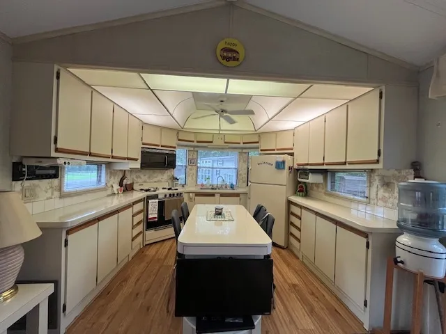 a kitchen with a sink appliances and cabinets