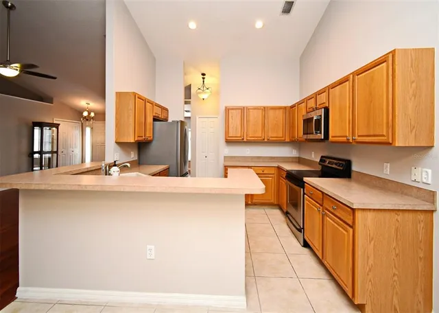 a kitchen with stainless steel appliances granite countertop a sink and cabinets