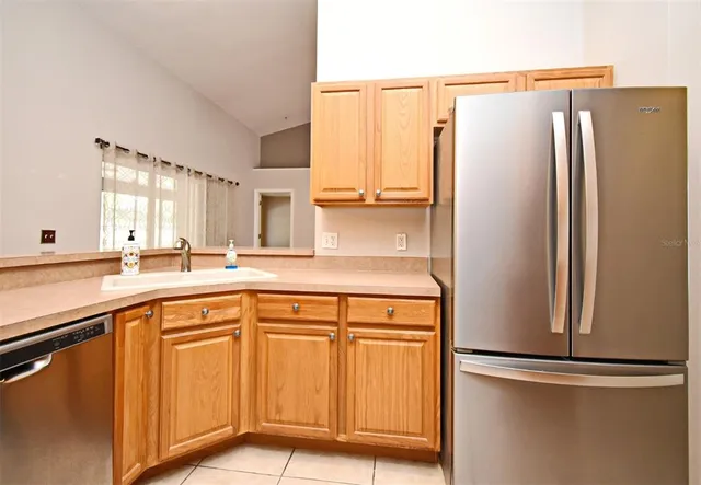 a kitchen with stainless steel appliances white cabinets and a refrigerator