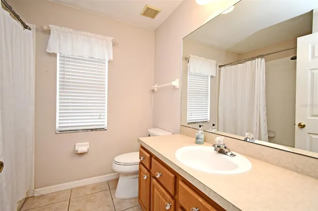 a bathroom with a sink double vanity and a toilet