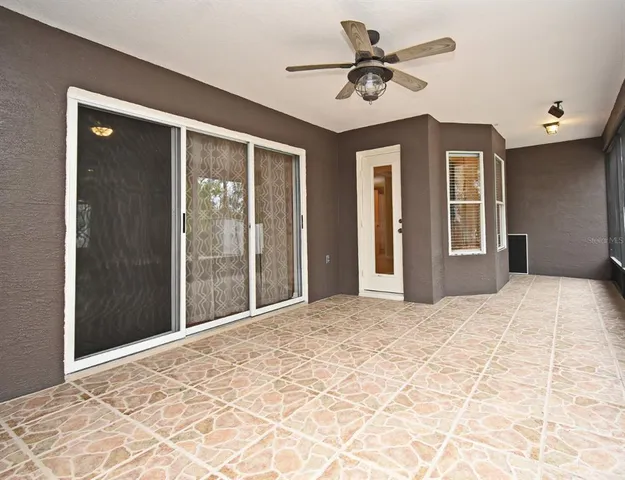 a view of an empty room with a ceiling fan