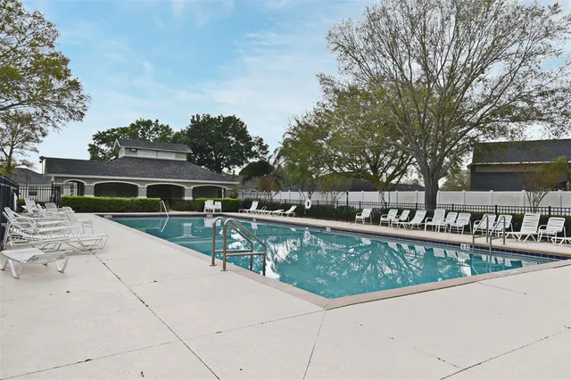a view of swimming pool with outdoor seating and plants