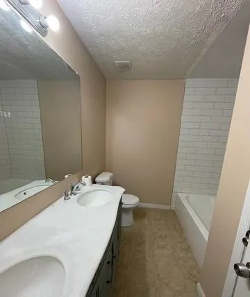 a bathroom with a sink a tub and a mirror