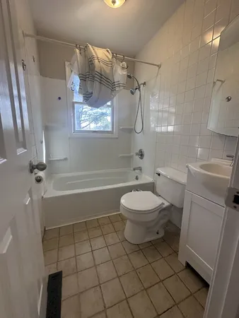 a bathroom with a toilet a sink and bathtub