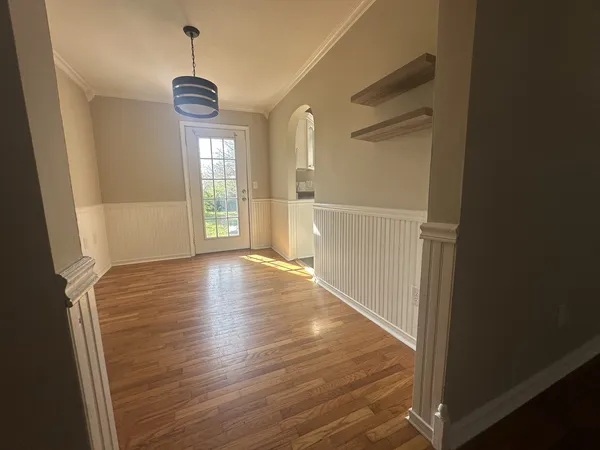 a view of a room with wooden floor and window