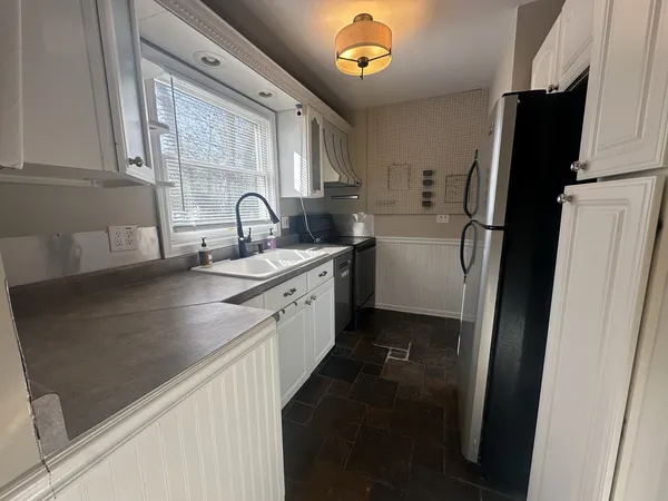 a kitchen with a refrigerator and a sink