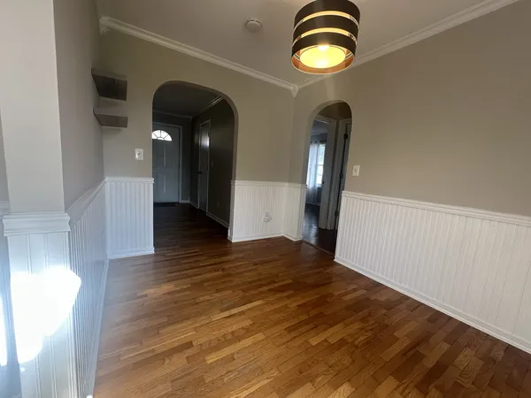 a view of entryway and hall with wooden floor
