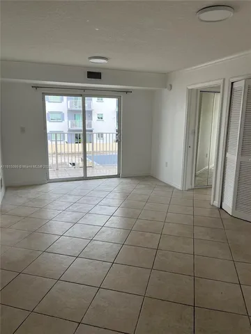 a view of an empty room and a window