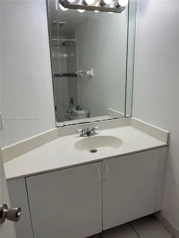 a bathroom with a sink and mirror
