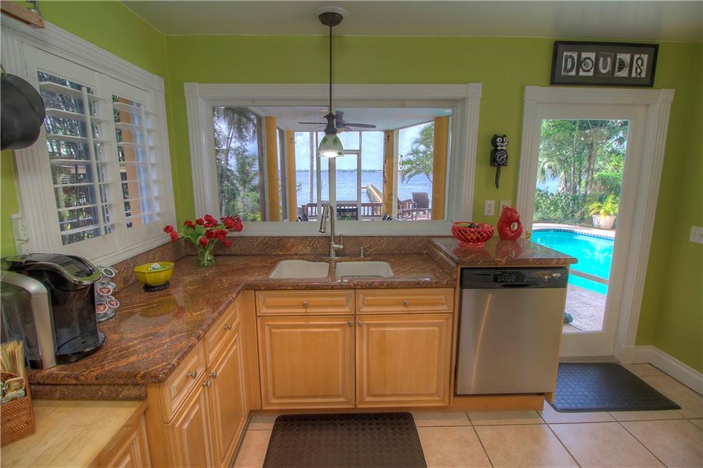 1509 Southeast Riverside Drive Stuart, FL 34996 - Photo 10 of 26 a kitchen with a sink and cabinets