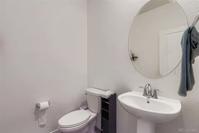 a bathroom with a sink a mirror and a toilet