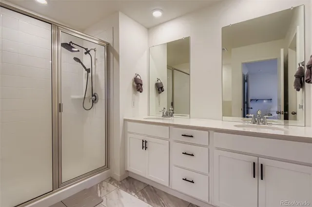 a bathroom with a shower sink and mirror
