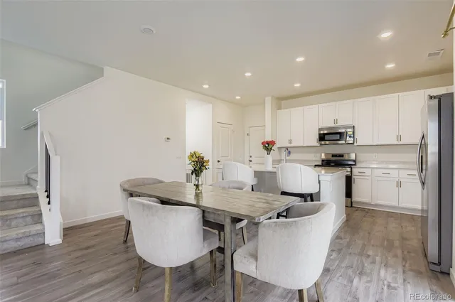 a kitchen with granite countertop kitchen island white cabinets and stainless steel appliances