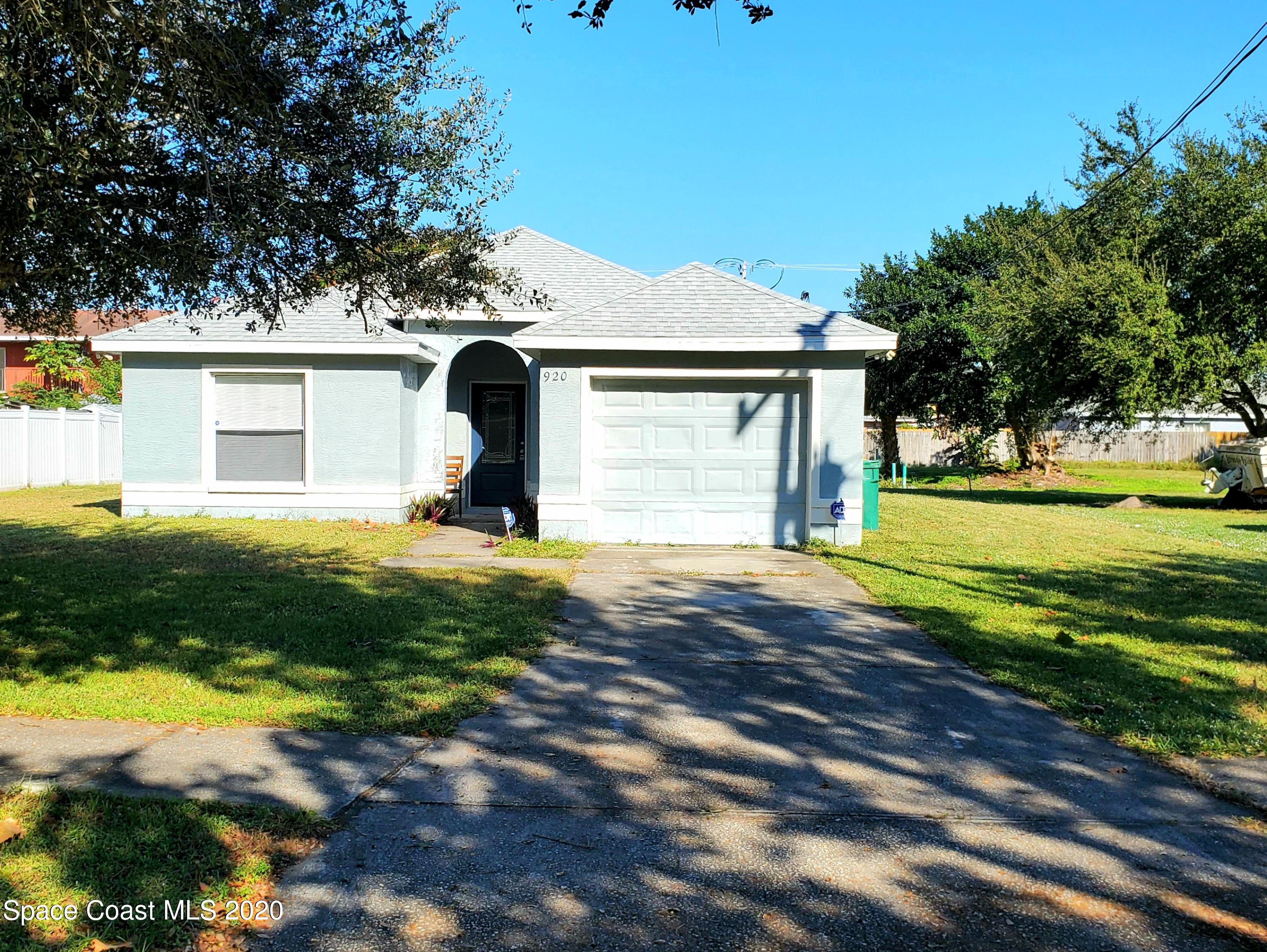 920 Grove Avenue Cocoa, FL 32922 - Photo 1 of 13 a front view of house with yard and green space