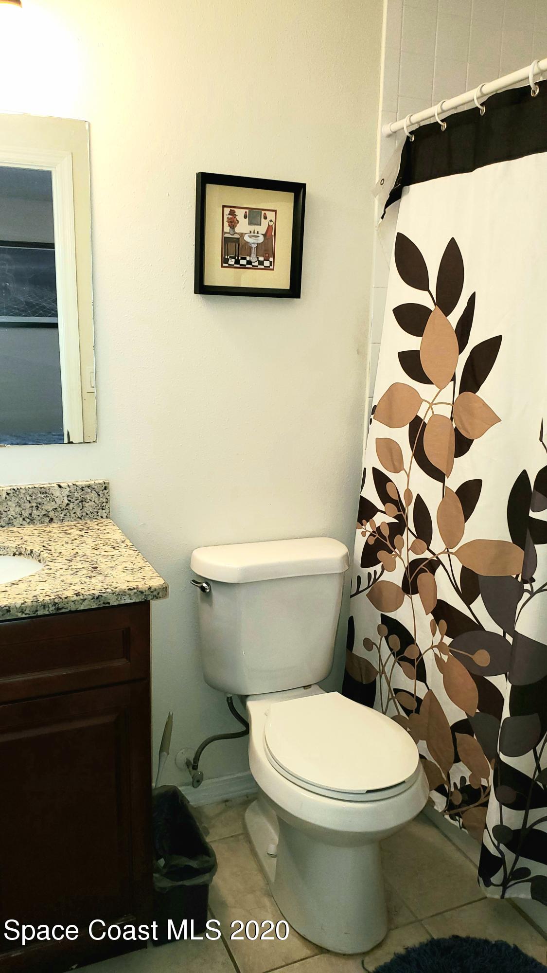 920 Grove Avenue Cocoa, FL 32922 - Photo 12 of 13 a white toilet sitting next to a bathroom sink