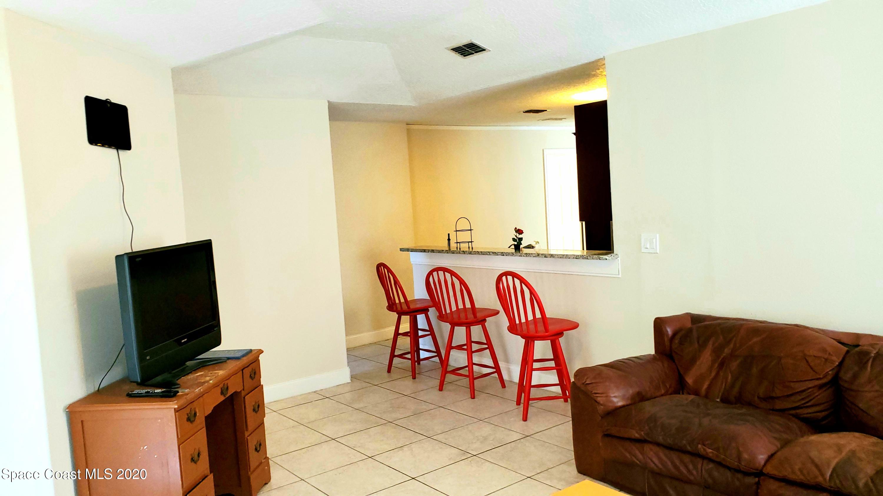 920 Grove Avenue Cocoa, FL 32922 - Photo 8 of 13 a living room with furniture and a flat screen tv