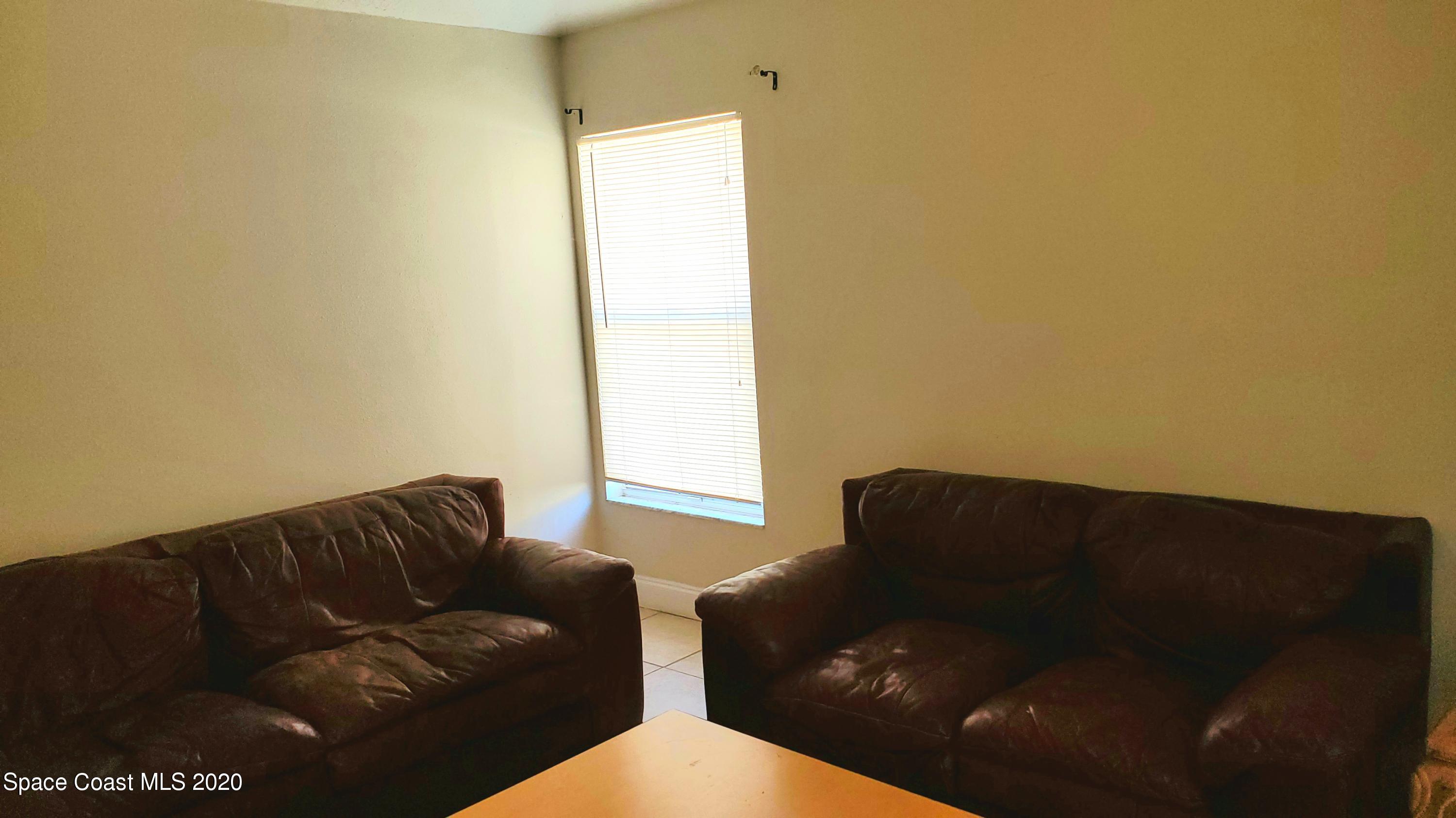 920 Grove Avenue Cocoa, FL 32922 - Photo 9 of 13 a living room with furniture and a window
