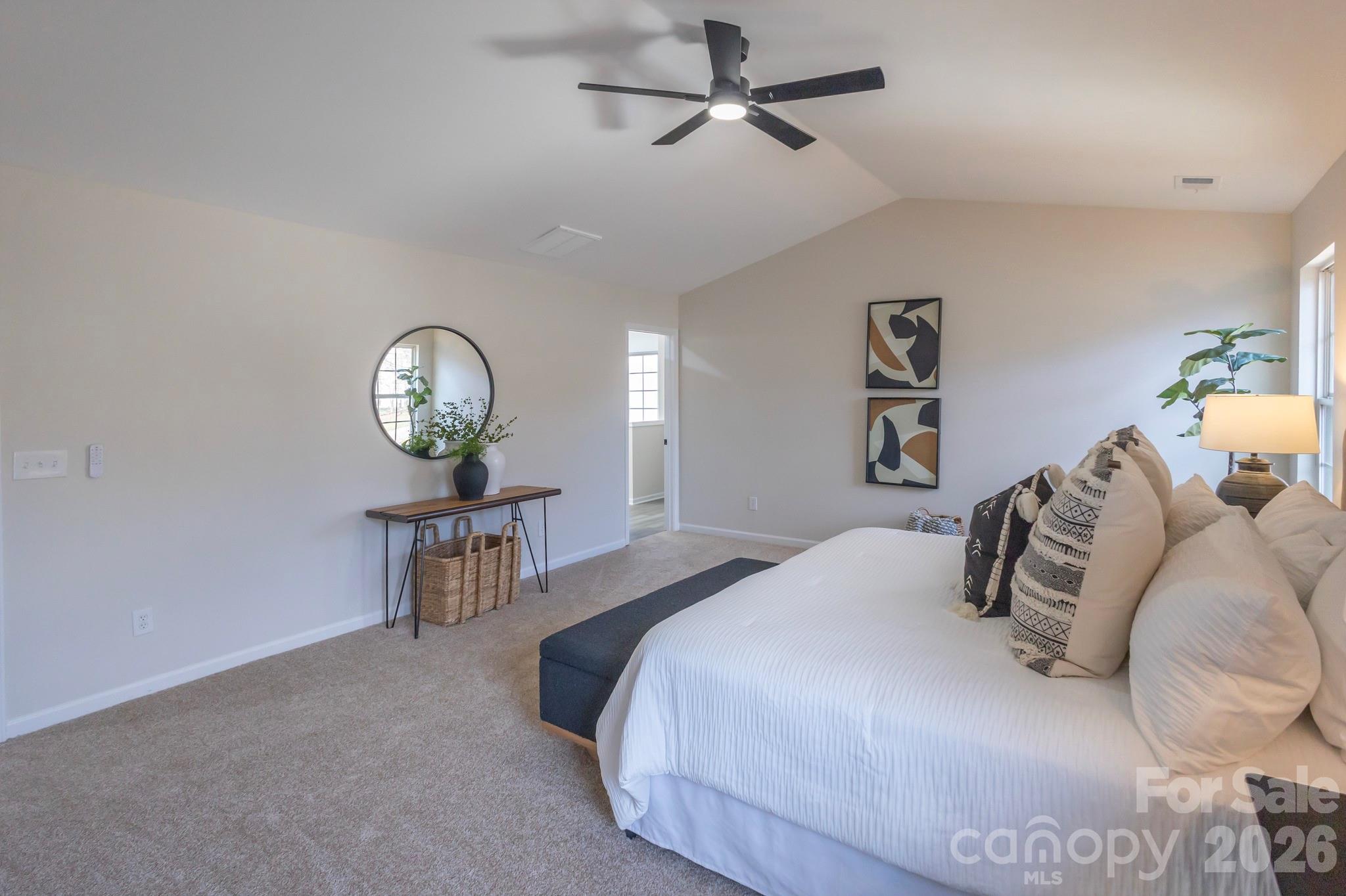 10631 Atkins Ridge Drive Charlotte, NC 28213 - Photo 16 of 38 a bedroom with a bed and a chandelier