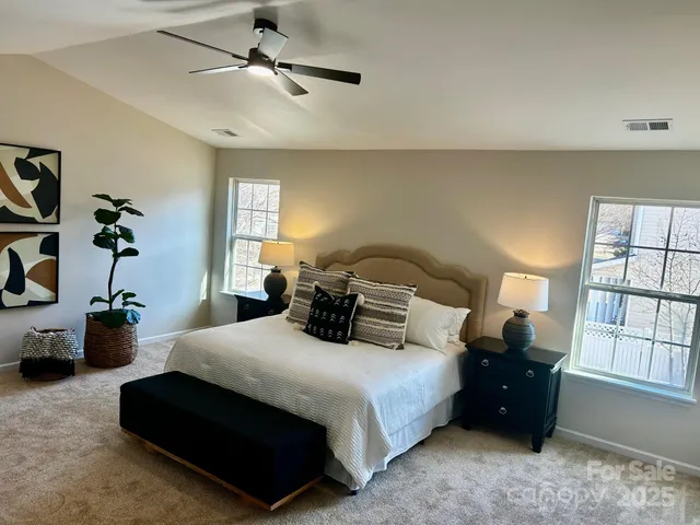 a bedroom with bed dresser and window