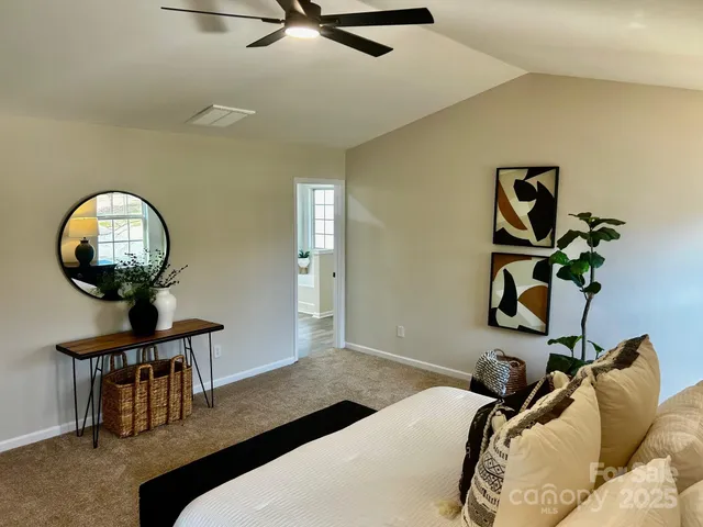 a bedroom with a bed and a mirror