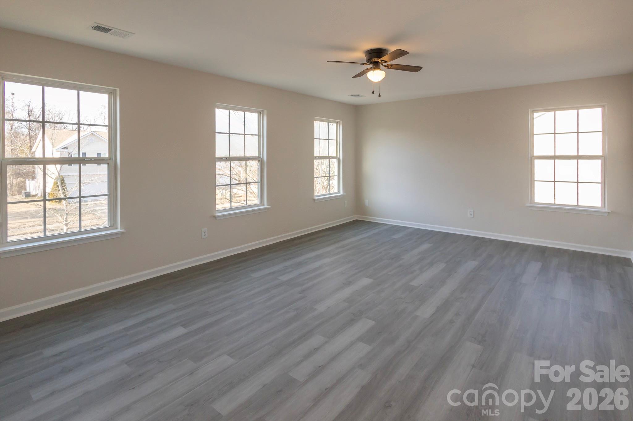 10631 Atkins Ridge Drive Charlotte, NC 28213 - Photo 24 of 38 a view of an empty room with a window and wooden floor