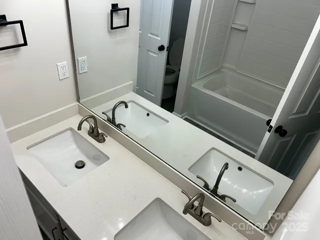 a bathroom with a sink and mirror