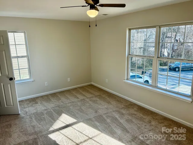 a view of a livingroom with a ceiling fan and window