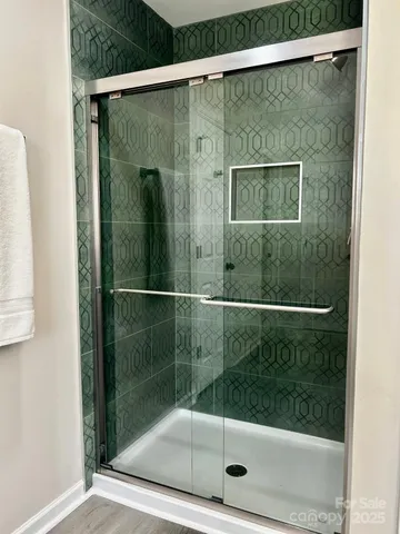 a bathroom with a glass shower door