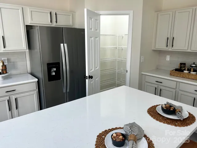 a kitchen with a refrigerator and a stove