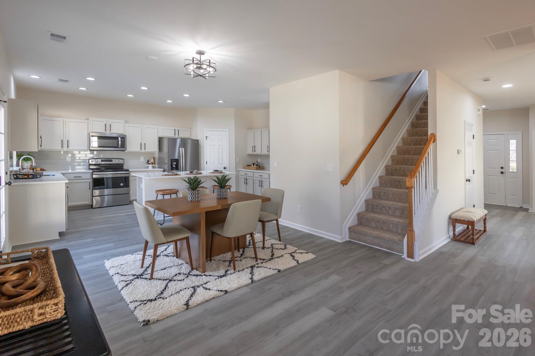 10631 Atkins Ridge Drive Charlotte, NC 28213 - Photo 7 of 38 a view of a dining room with furniture and wooden floor