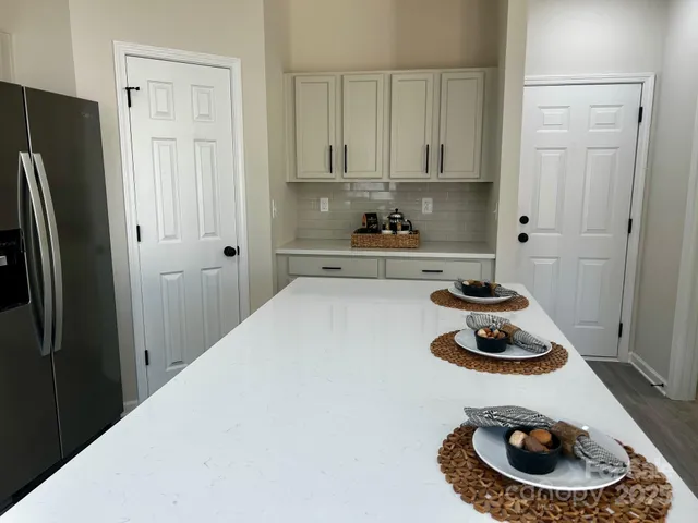 a kitchen with a refrigerator and a stove