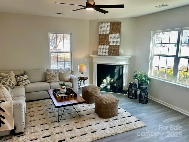 a living room with furniture and a fireplace