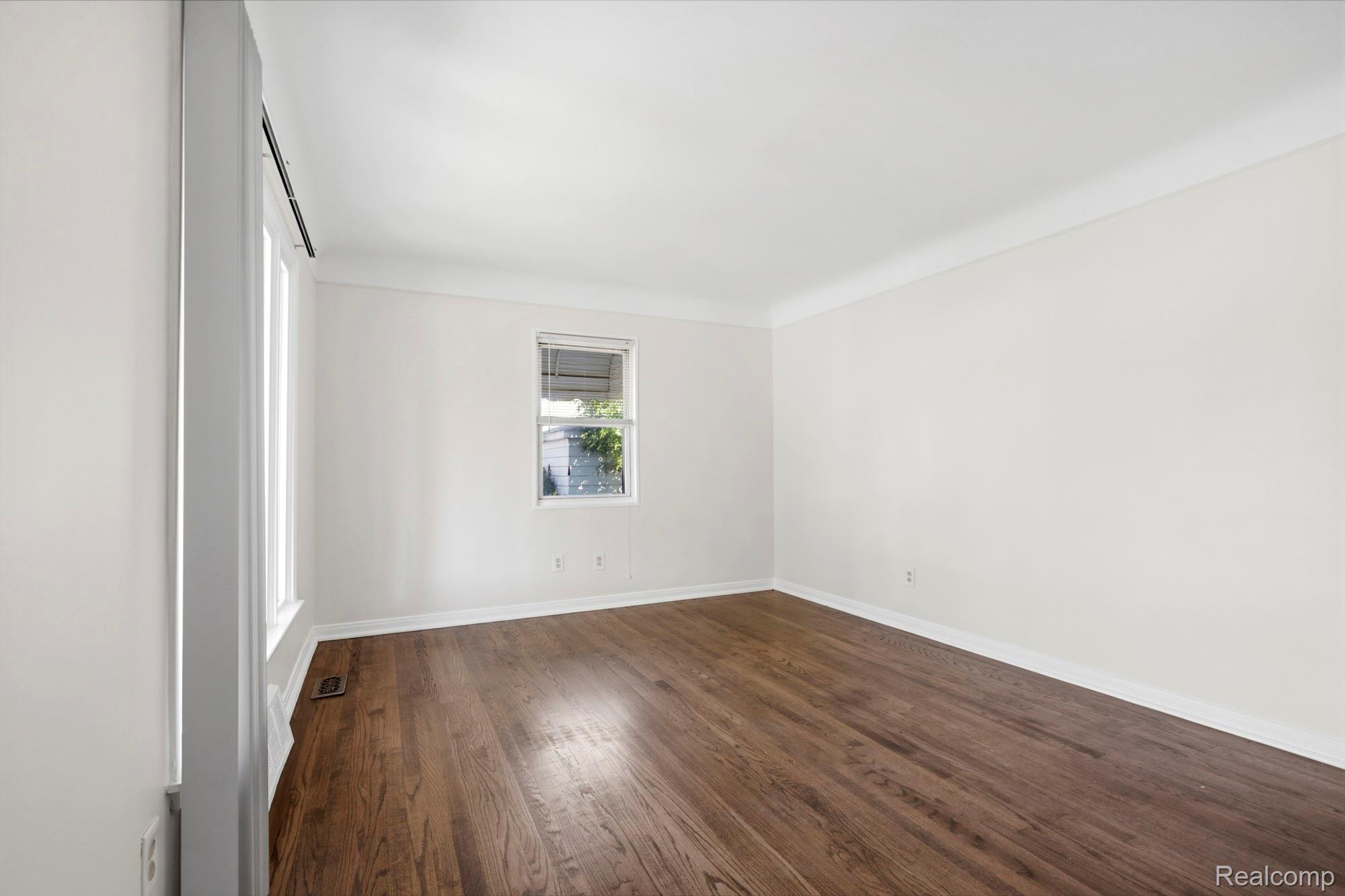 970 Champaign Road Lincoln Park, MI 48146 - Photo 14 of 28 Empty room featuring dark wood-style flooring and baseboards