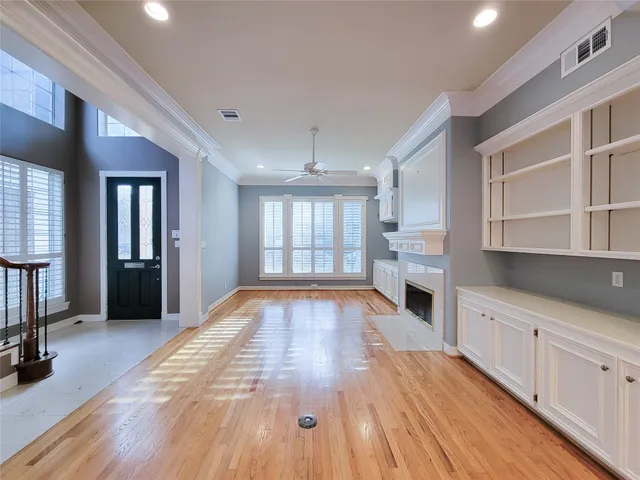 a view of a kitchen with cabinets and wooden floor