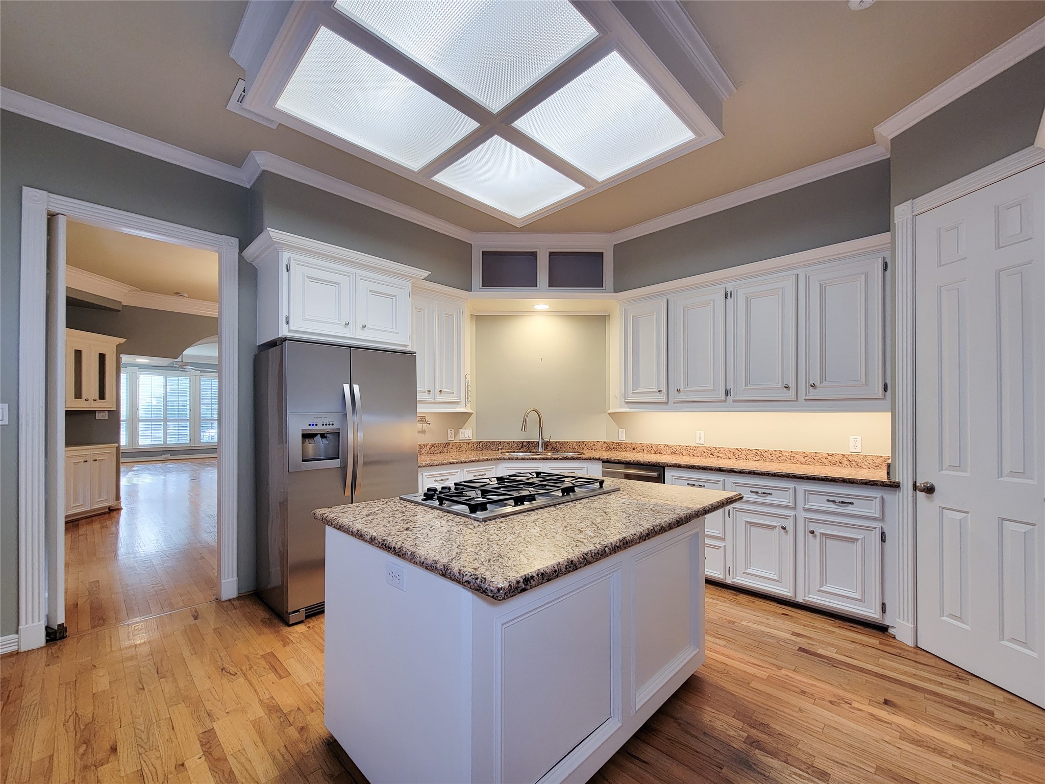 6304 Pickens Street, Unit B Houston, TX 77007 - Photo 5 of 15 a kitchen with stainless steel appliances granite countertop wooden cabinets a stove a sink and a refrigerator