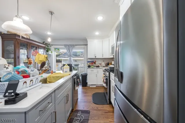 a kitchen with a sink appliances and cabinets