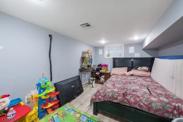 a bed room with a bed mirror and a table