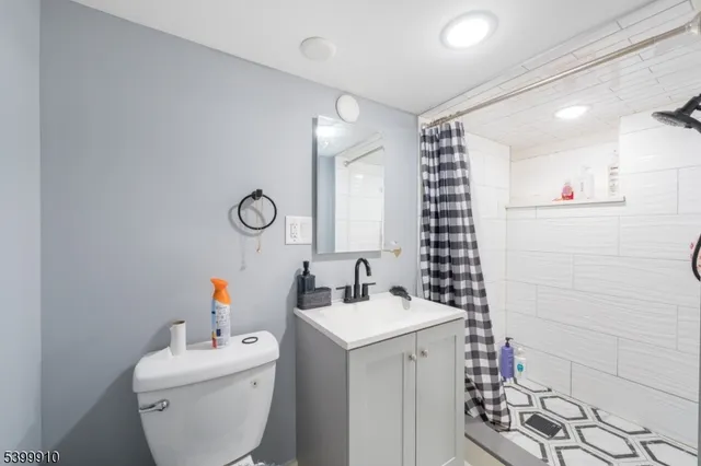 a bathroom with a sink mirror vanity and toilet