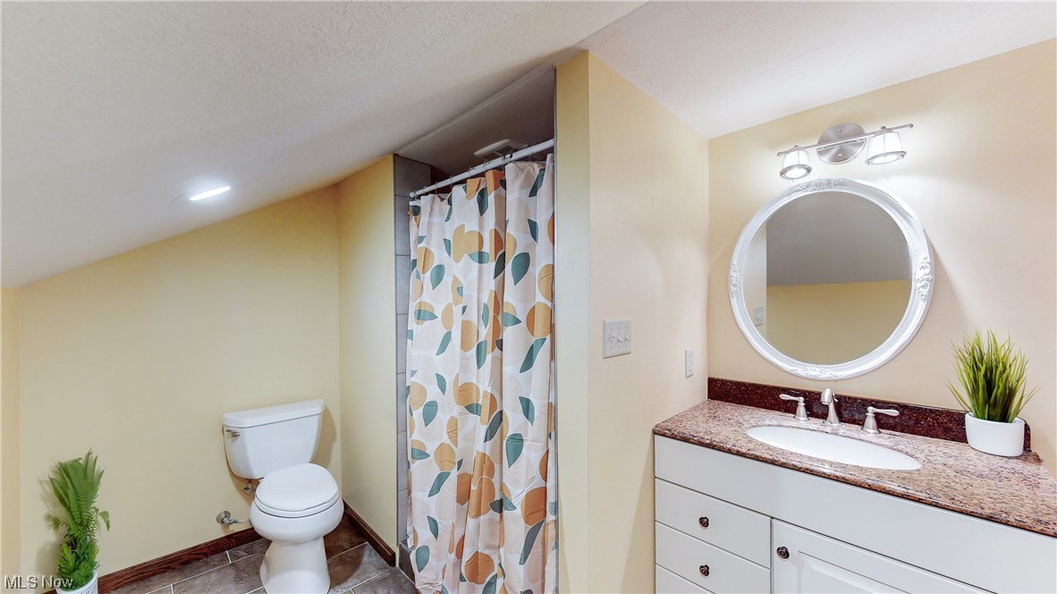 5770 Horning Road Kent, OH 44240 - Photo 29 of 50 Bathroom featuring a textured ceiling, vanity, toilet, and tile flooring