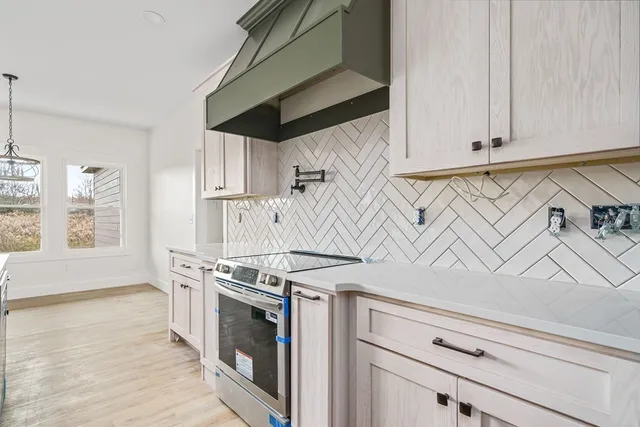 a kitchen with stainless steel appliances granite countertop a stove and a microwave