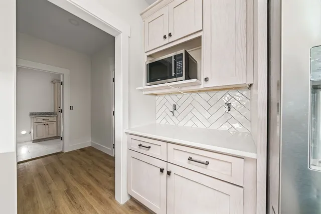 a view of kitchen with microwave and cabinets